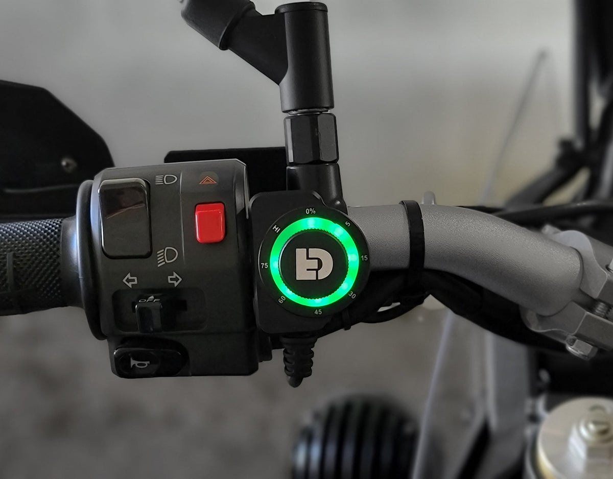 DENALI DialDim Lighting Controller installed on a motorcycle handlebar